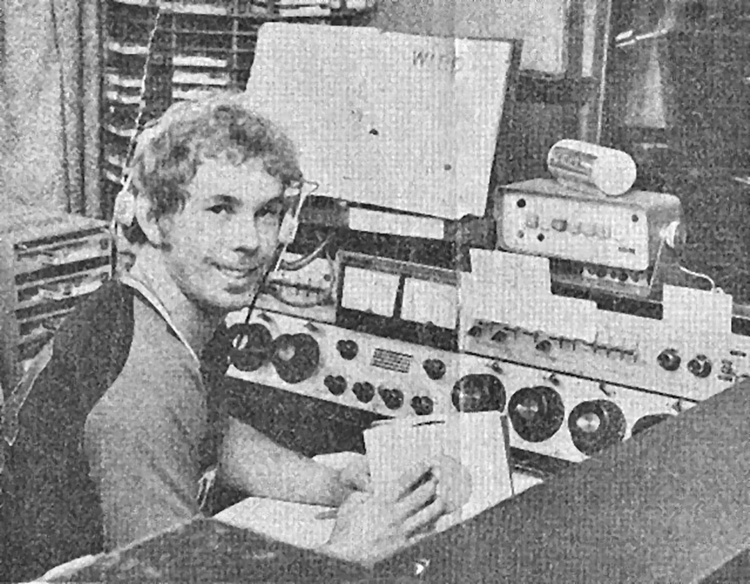 A broadcaster at work in a vintage radio studio control room